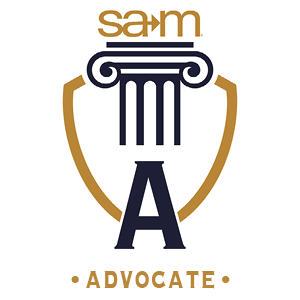 SAM Advocate badge featuring a gold and navy shield with a classical column at the center. The letter "A" is displayed prominently below the column, representing the Advocate giving level in the Pillars of Progress program. The SAM logo appears above the column.