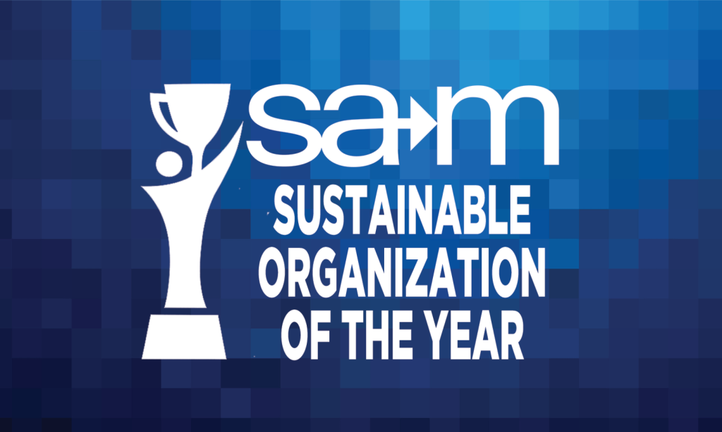 On a blue pixelated gradient background, a white stylized figure holds up a trophy beside the white SAM logo with an integrated arrow, and below it the bold white text reads “Sustainable Organization of the Year.”